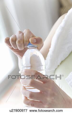 A Woman Opening A Bottle of Water, Close Up View Large Photo Image Stock Photo - A Woman Opening A Bottle of Water, Close Up. Fotosearch