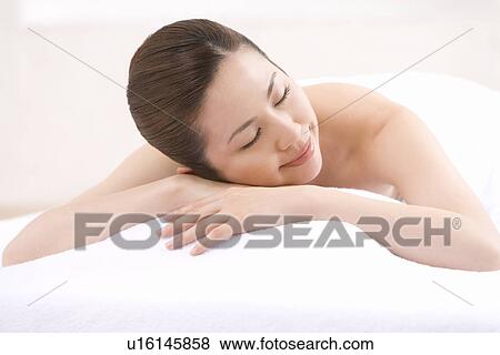 A Young Woman Having Beauty Salon Treatments, Lying on Stomach, Eyes Closed, Side View View Large Photo Image Stock Photo - A Young Woman Having Beauty Salon Treatments, Lying on Stomach, Eyes Closed, Side View. Fotosearch