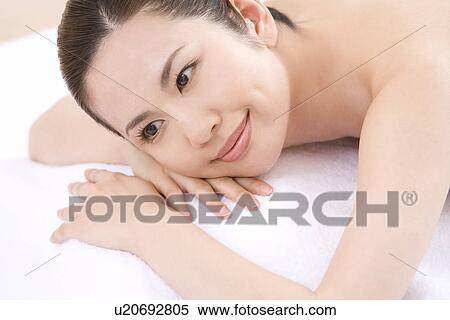 A Young Woman Having Beauty Salon Treatments, Lying on Stomach, High Angle View View Large Photo Image Stock Photography - A Young Woman Having Beauty Salon Treatments, Lying on Stomach, High Angle View. Fotosearch