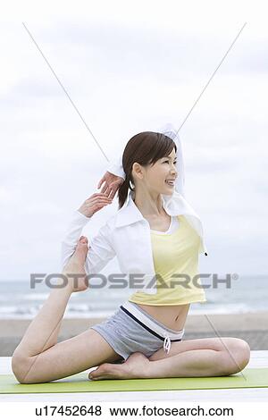 A Young Woman Stretching at Beach, Side View View Large Photo Image Stock Photo - A Young Woman Stretching at Beach, Side View. Fotosearch