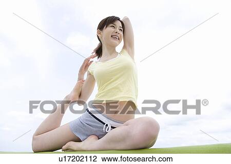 A Young Woman Stretching Outside, Low Angle View View Large Photo Image Stock Image - A Young Woman Stretching Outside, Low Angle View. Fotosearch