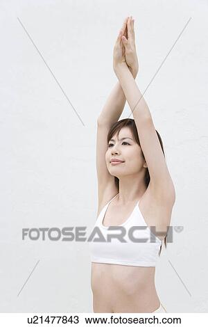 Stock Image - A Young Woman Stretching, Side View. Fotosearch