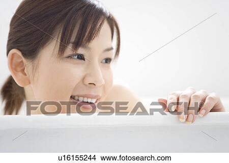 Close-up Image of A Smiling Young Woman, Side View View Large Photo Image Picture - Close-up Image of A Smiling Young Woman, Side View. Fotosearch