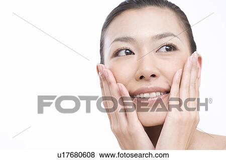 Stock Photo - Close-up Image of A Young Woman's Face, Putting Hands on Cheek, Front View, Copy Space. Fotosearch