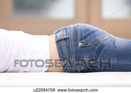 Stock Photo - Close Up Image of A Young Woman's Hip, Lying on Stomach, Close Up, No Face, Side View, Differential Focus. Fotosearch