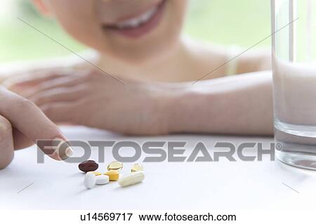 Diet Supplements on Table, Glass of Water Next to It, Close Up, Differential Focus View Large Photo Image Stock Photo - Diet Supplements on Table, Glass of Water Next to It, Close Up, Differential Focus. Fotosearch