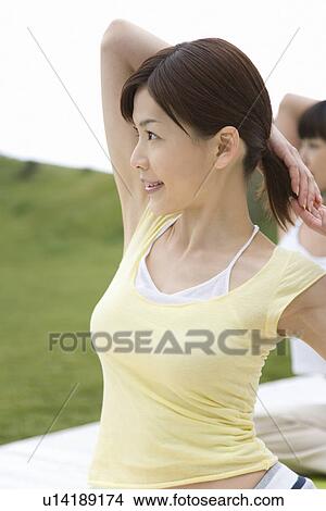 Two Young Woman Practicing Yoga, Side View, Differential Focus View Large Photo Image Picture - Two Young Woman Practicing Yoga, Side View, Differential Focus. Fotosearch