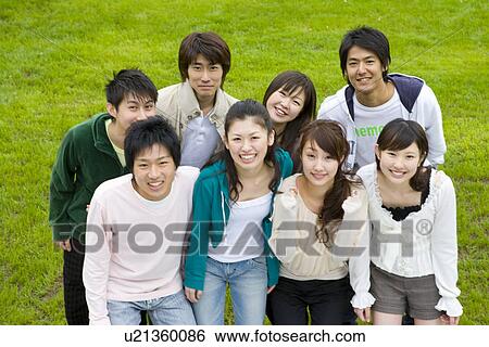 Portrait of a medium group of young people on lawn, smiling and looking at camera, high angle view, Japan View Large Photo Image Stock Photograph - Portrait of a medium group of young people on lawn, smiling and looking at camera, high angle view, Japan. Fotosearch