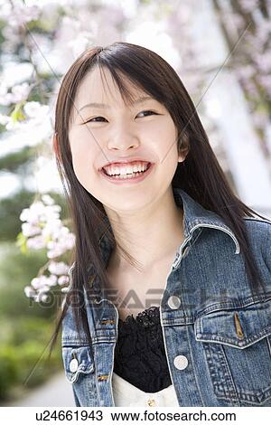 Woman smiling and standing under the cherry tree, front view, Japan View Large Photo Image Stock Image - Woman smiling and standing under the cherry tree, front view, Japan. Fotosearch