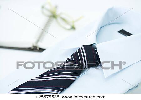 Folded shirt and tie, glasses on notebook in background, high angle view, close up, Japan View Large Photo Image Stock Photo - Folded shirt and tie, glasses on notebook in background, high angle view, close up, Japan. Fotosearch