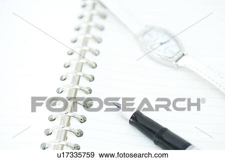 Stock Photo - Pen and wristwatch on notebook, high angle view, close up, Japan. Fotosearch
