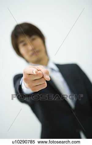Portrait of young businessman pointing forward, front view, white background, differential focus, Japan View Large Photo Image Stock Photography - Portrait of young businessman pointing forward, front view, white background, differential focus, Japan. Fotosearch