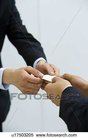 Two businessmen exchanging a business card, high angle view, white background View Large Photo Image Stock Photography - Two businessmen exchanging a business card, high angle view, white background. Fotosearch