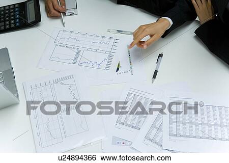 Stock Photograph - Two young businessmen in meeting, high angle view, Japan. Fotosearch