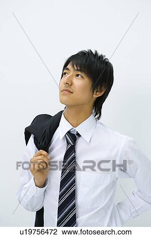 Young businessman holding jacket on his shoulder, front view, white background, Japan View Large Photo Image Stock Image - Young businessman holding jacket on his shoulder, front view, white background, Japan. Fotosearch