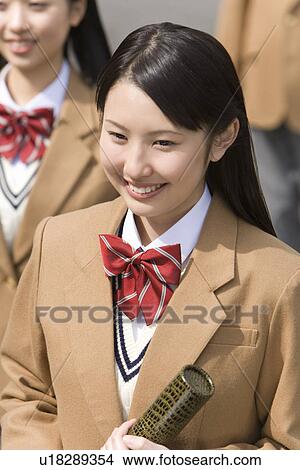 Teenage girl smiling and holding diploma, high angle view, Japan View Large Photo Image Picture - Teenage girl smiling and holding diploma, high angle view, Japan. Fotosearch