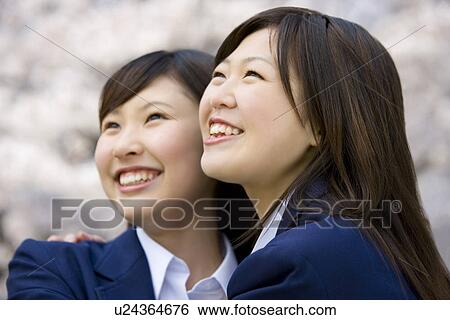Teenage girls smiling and looking up, side view, Japan View Large Photo Image Stock Photograph - Teenage girls smiling and looking up, side view, Japan. Fotosearch