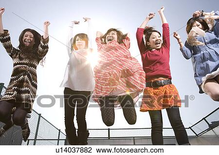 Stock Image - College Students Jumping. Fotosearch