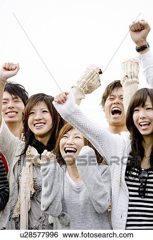 Stock Photograph - Five College Students Cheering with Arms Up in Air. Fotosearch