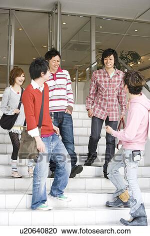 Stock Image - Five College Students Talking at Stairs. Fotosearch