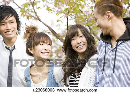 Stock Image - Four College Students Talking On Campus. Fotosearch