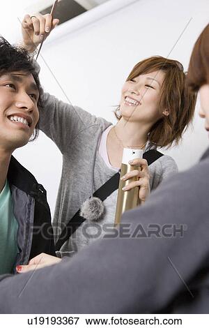Stock Photo - Three College Students Doing Make Up. Fotosearch