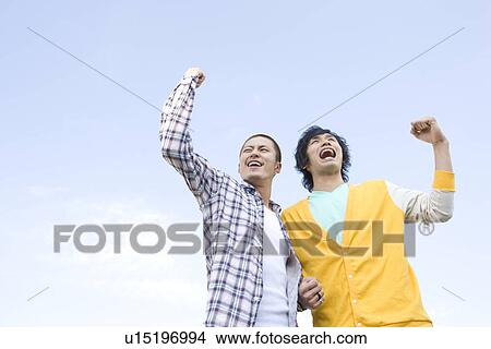 Picture - Two Young Men Punching the Air. Fotosearch