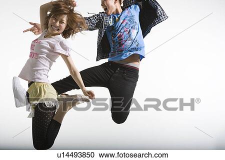 Stock Image - Young Couple Jumping. Fotosearch