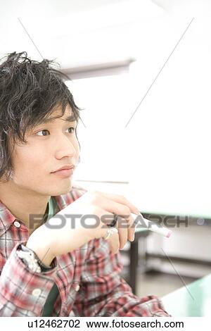 Stock Image - Young Man in Class. Fotosearch
