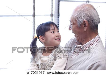 Girl smiling to her grandfather View Large Photo Image Stock Photo - Girl smiling to her grandfather. Fotosearch