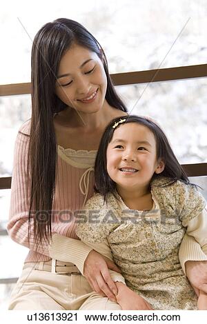 Girl with mother smiling View Large Photo Image Stock Image - Girl with mother smiling. Fotosearch