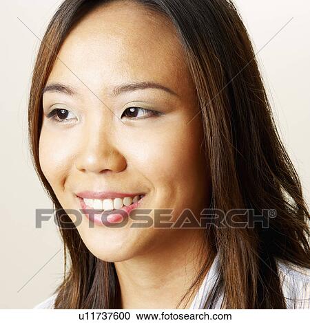 Stock Image - Close-up of a young woman smiling. Fotosearch