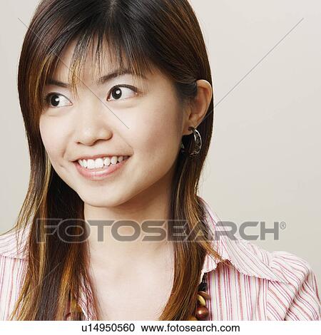 Stock Image - Close-up of a young woman smiling. Fotosearch