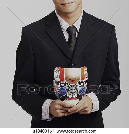 Portrait of a businessman holding a mask and smiling View Large Photo Image Stock Image - Portrait of a businessman holding a mask and smiling. Fotosearch
