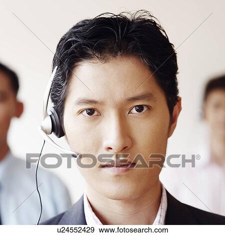 Stock Photo - Portrait of a male customer service representative with two colleagues. Fotosearch