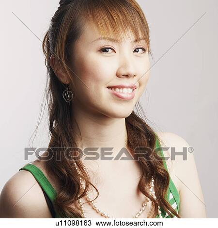Stock Image - Portrait of a young woman smiling. Fotosearch