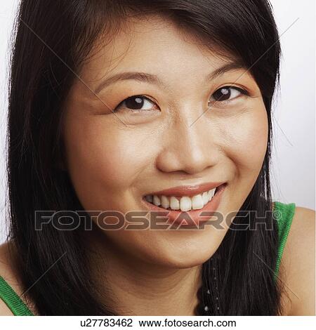 Stock Image - Portrait of a young woman smiling. Fotosearch