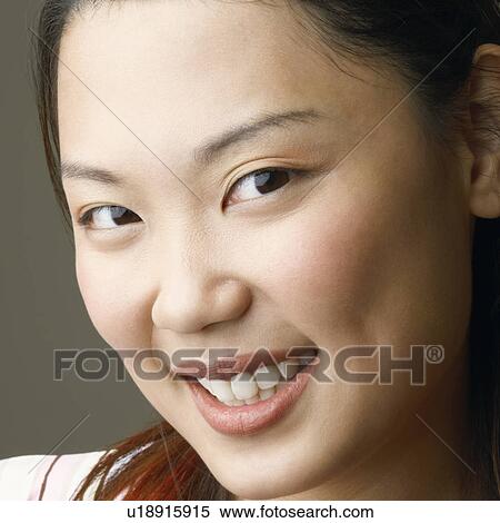 Stock Photography - Portrait of a young woman smiling. Fotosearch