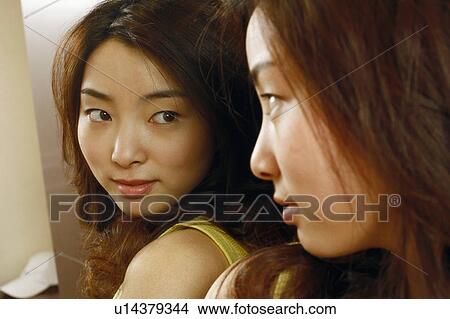 Close-up of a young woman looking in the mirror View Large Photo Image Picture - Close-up of a young woman looking in the mirror. Fotosearch
