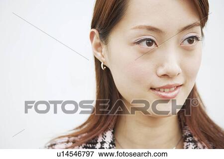 Close-up of a young woman smiling View Large Photo Image Stock Photo - Close-up of a young woman smiling. Fotosearch