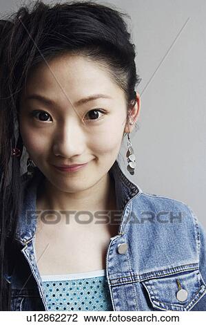 Stock Image - Portrait of a young woman smiling. Fotosearch