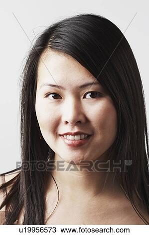 Stock Image - Portrait of a young woman smiling. Fotosearch