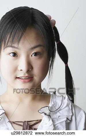 Portrait of a young woman smiling View Large Photo Image Stock Image - Portrait of a young woman smiling. Fotosearch