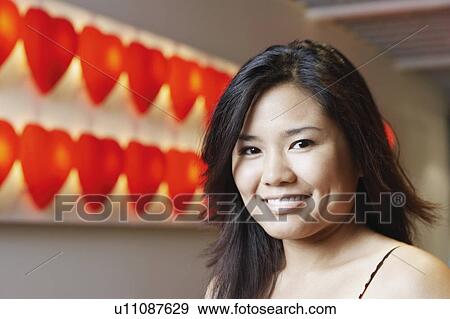 Stock Photo - Portrait of a young woman smiling. Fotosearch