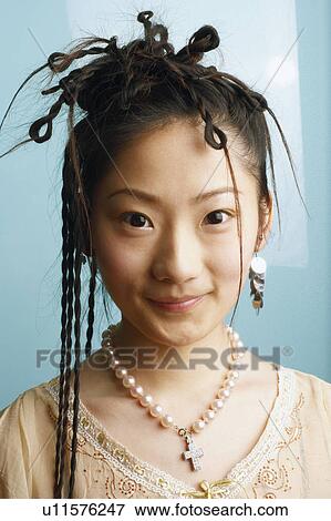 Portrait of a young woman smiling View Large Photo Image Stock Photo - Portrait of a young woman smiling. Fotosearch