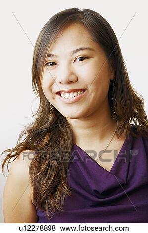 Portrait of a young woman smiling View Large Photo Image Stock Photo - Portrait of a young woman smiling. Fotosearch