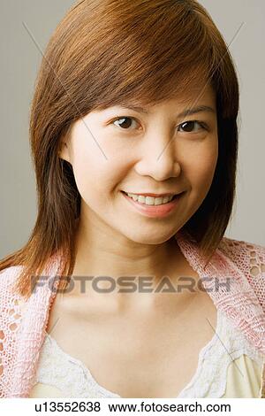 Stock Photo - Portrait of a young woman smiling. Fotosearch