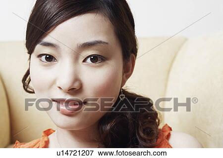 Stock Photo - Portrait of a young woman smiling. Fotosearch