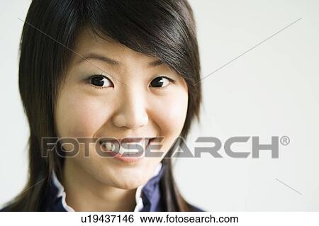 Stock Photograph - Portrait of a young woman smiling. Fotosearch