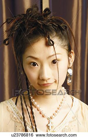 Stock Photograph - Portrait of a young woman smiling. Fotosearch